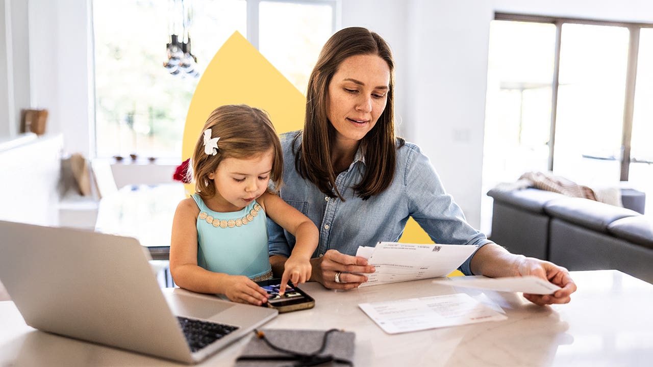 design image of a woman and her daughter at a table, woman reading bills
