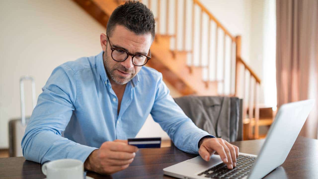 Modern businessman using laptop and credit card