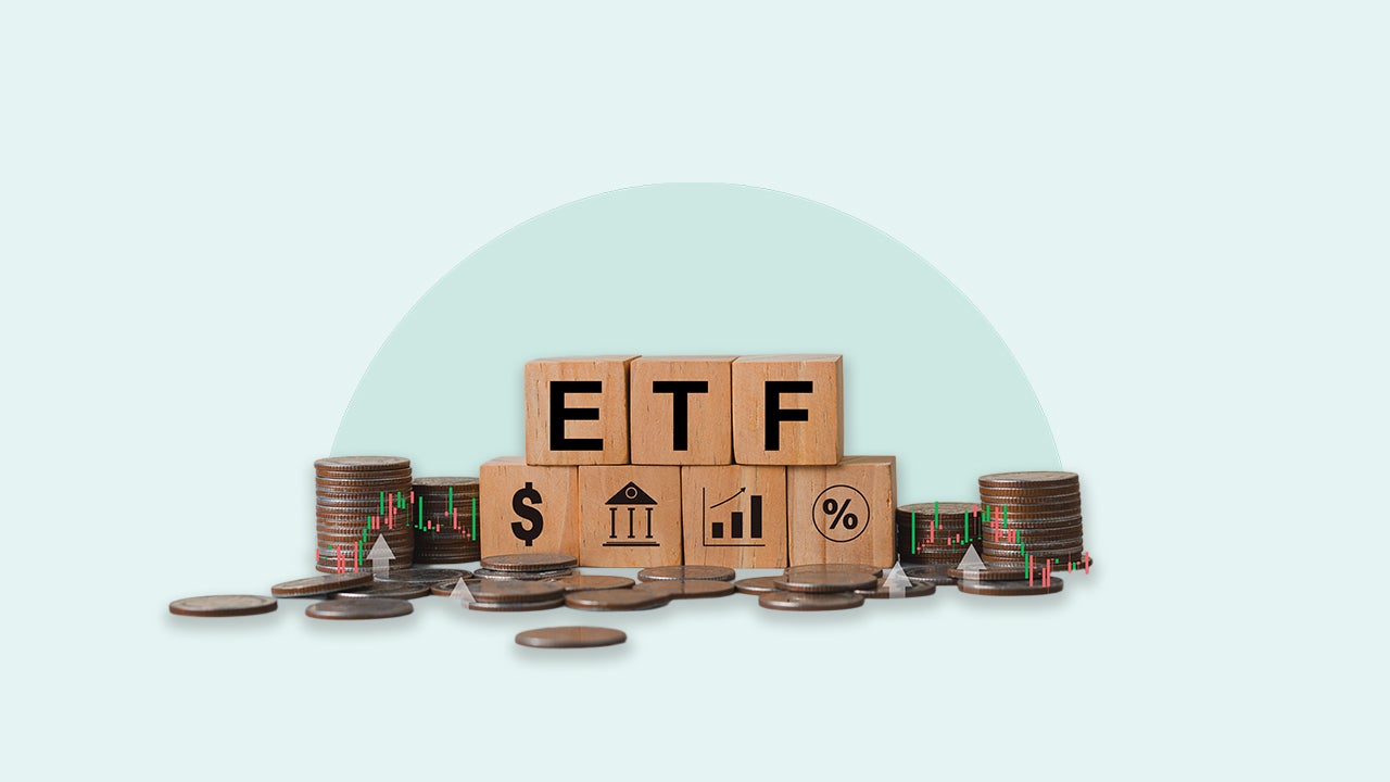 Wood blocks that say ETF are stacked among coins on a blue background.