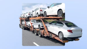 A truck hauling a number of white passenger vehicles in two stacks. The image is imposed over an illustrated blue background.
