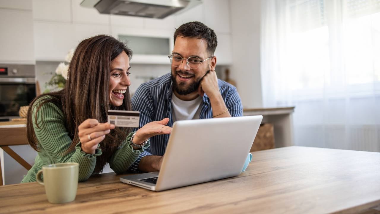 Man and woman shopping from the comfort of their home