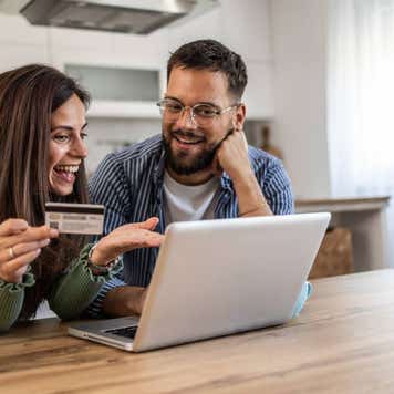 Man and woman shopping from the comfort of their home
