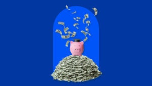 design image of a piggy bank with a graduation cap on top of a pile of money bills