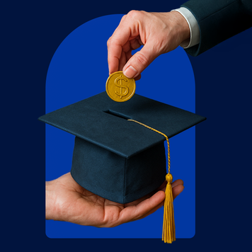 Hand holding a graduation cap with another hand inserting a coin into the top of the cap against a blue background.