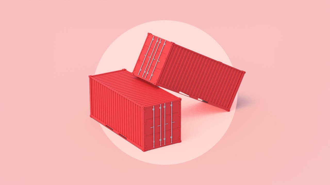 Two red shipping containers are stacked together on a pink background.