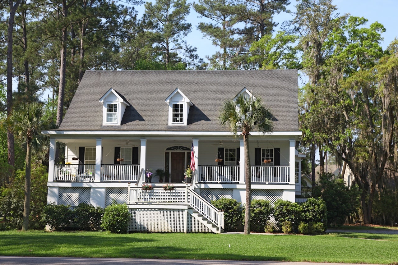 white house with raised front porch and palm tree in beaufort county, south carolina