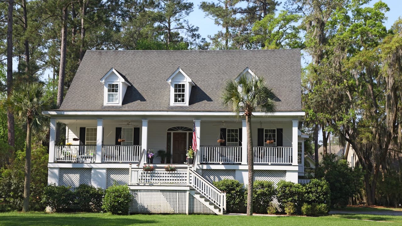 white house with raised front porch and palm tree in beaufort county, south carolina