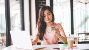 East Asian millennial woman investing in finances and technologies