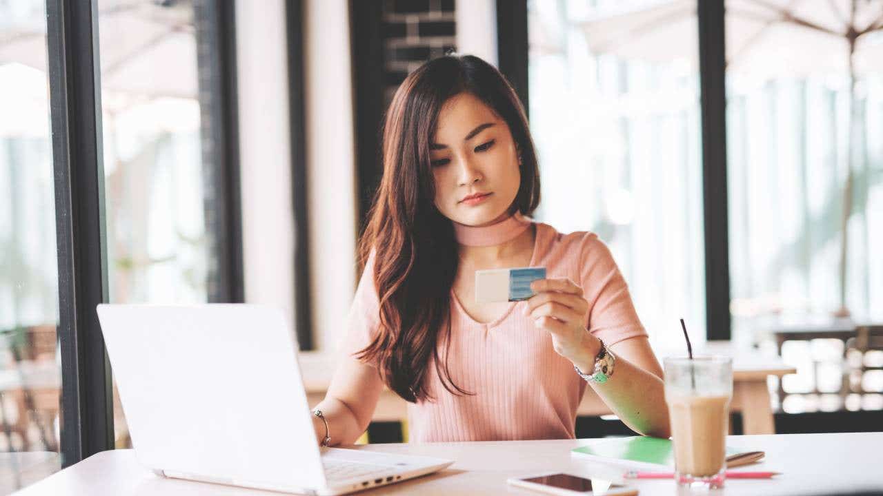 East Asian millennial woman investing in finances and technologies