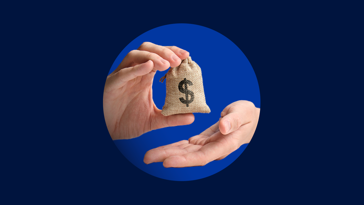 A close-up of two hands, one of them holding a mini money bag