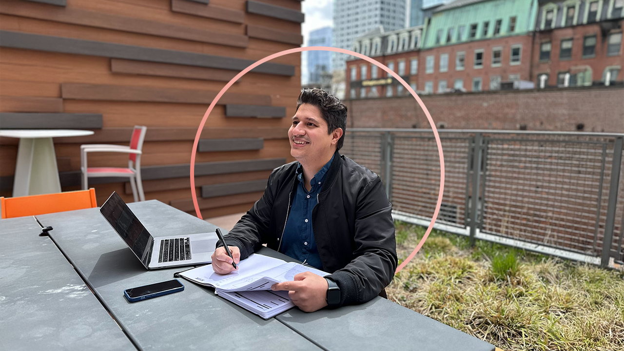 A photo of the author of the article near a computer and book