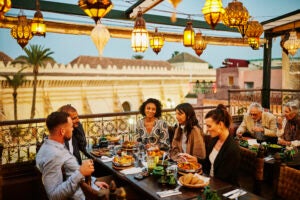 Group of adults dining at an outdoor restaurant
