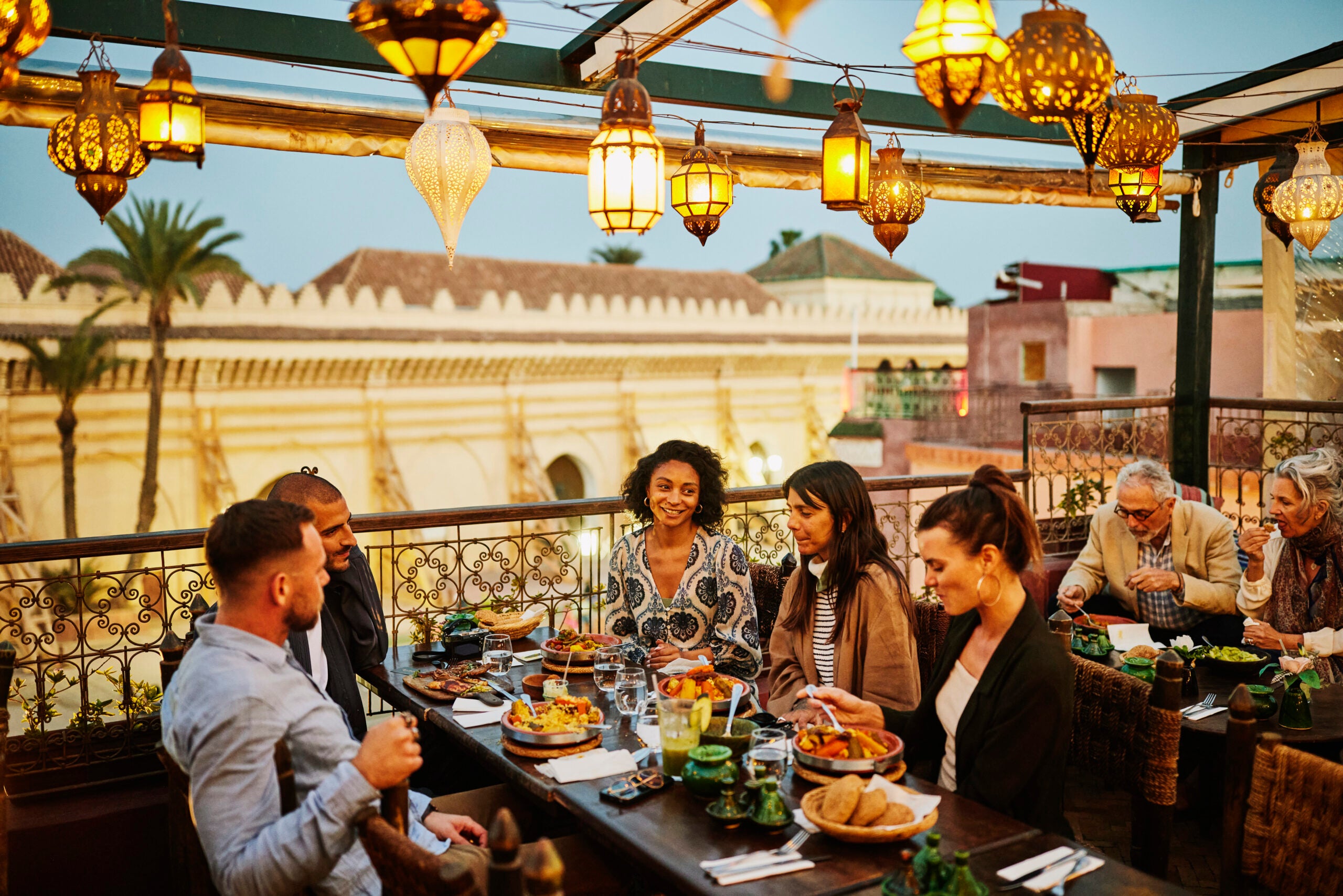 Group of adults dining at an outdoor restaurant