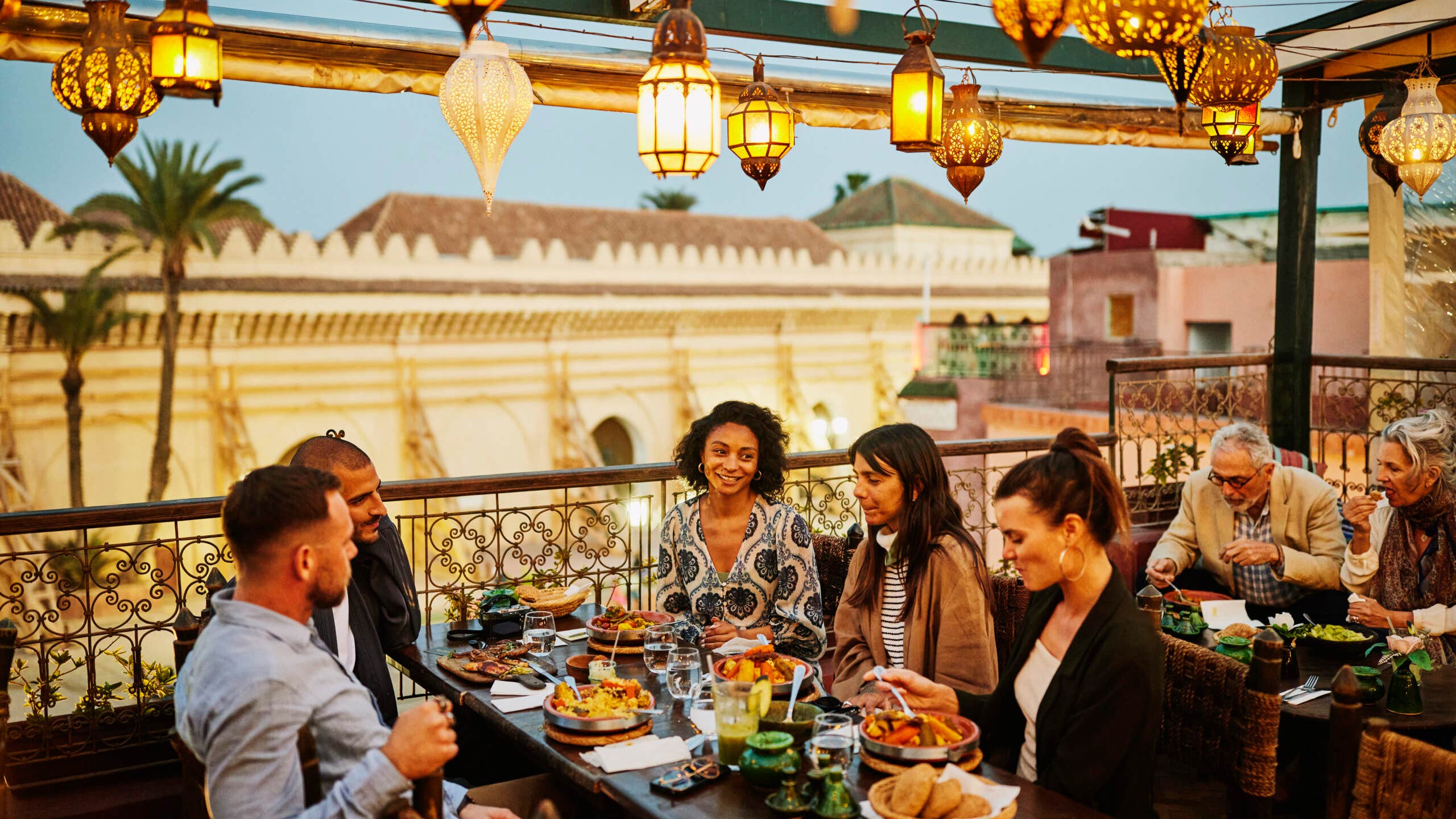 Group of adults dining at an outdoor restaurant