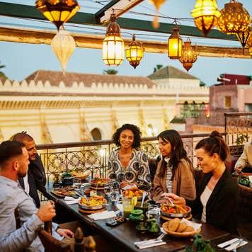 Group of adults dining at an outdoor restaurant