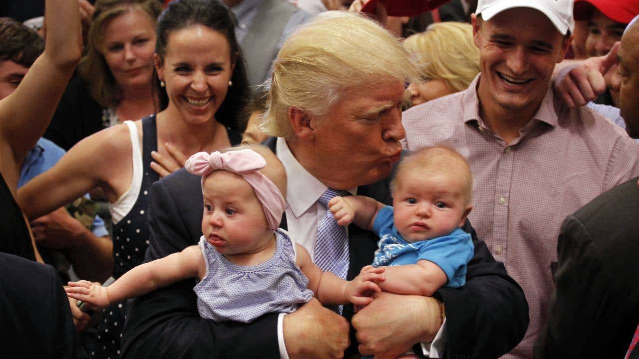 Donald Trump holding two babies.