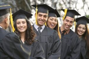 Graduate students standing in a row, outdoors