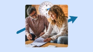 Older man with glasses sits on a couch next to a younger woman with curly hair. They are looking at official paperwork on a coffee table that also contains a calculator. There is an image of a large compass behind their heads and an blue arrow pointing from lower left to upper right.