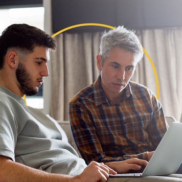 A man helps his college-aged son complete the FAFSA