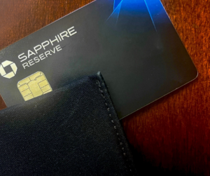 A black wallet sits on top of a sapphire reserve credit card.