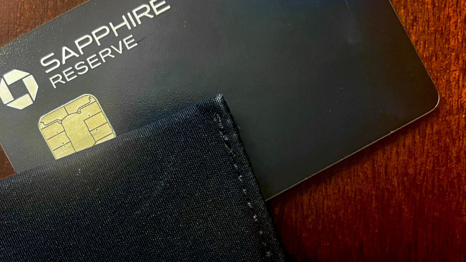 A black wallet sits on top of a sapphire reserve credit card.