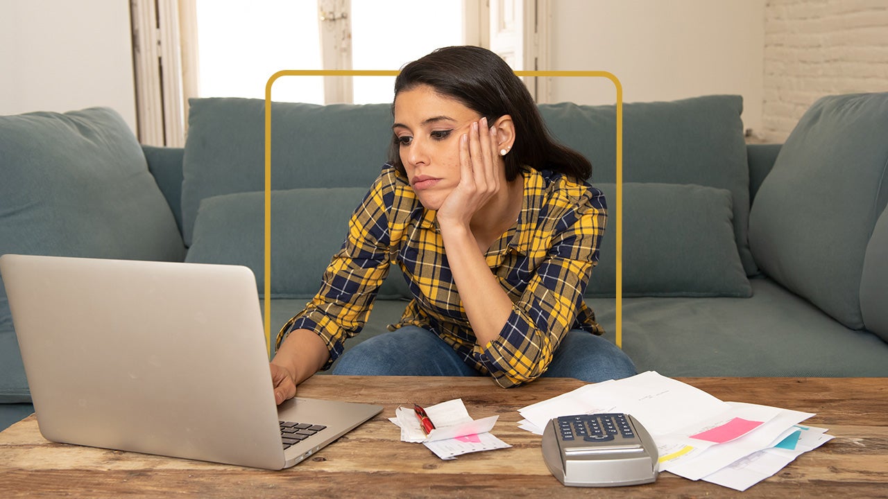 Woman staring glumly at her laptop with her chin perched on one hand.