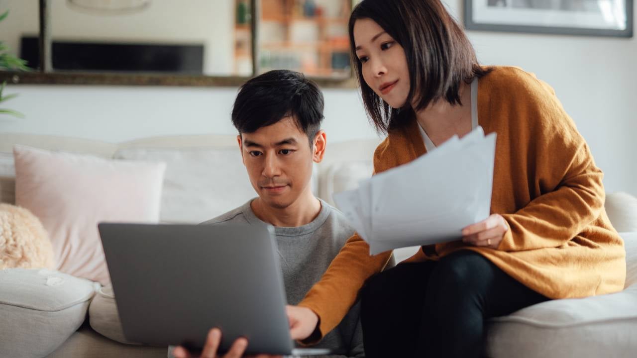 Couple looking at a laptop together.