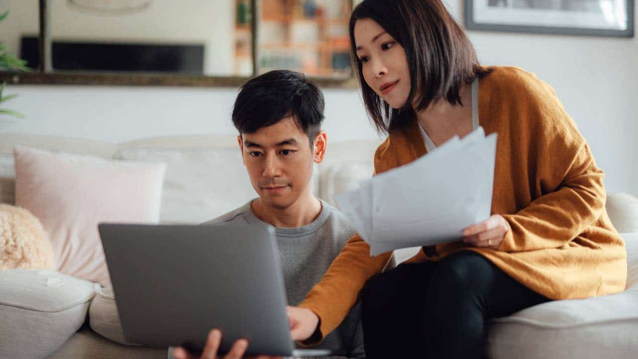 Couple looking at a laptop together.