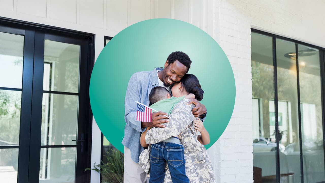 Family hugging inside home.