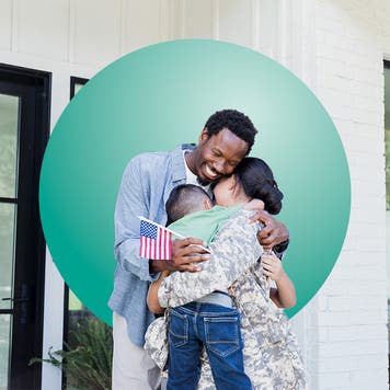 Family hugging inside home.