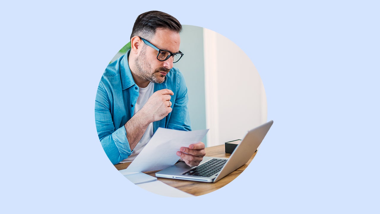A man looks at a laptop.