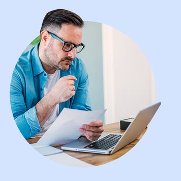 A man looks at a laptop.