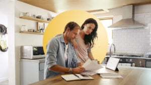 Middle-age couple looking over finances at their kitchen table
