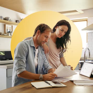 Middle-age couple looking over finances at their kitchen table