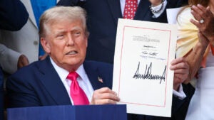 Donald Trump holds signed budget reconcilation bill