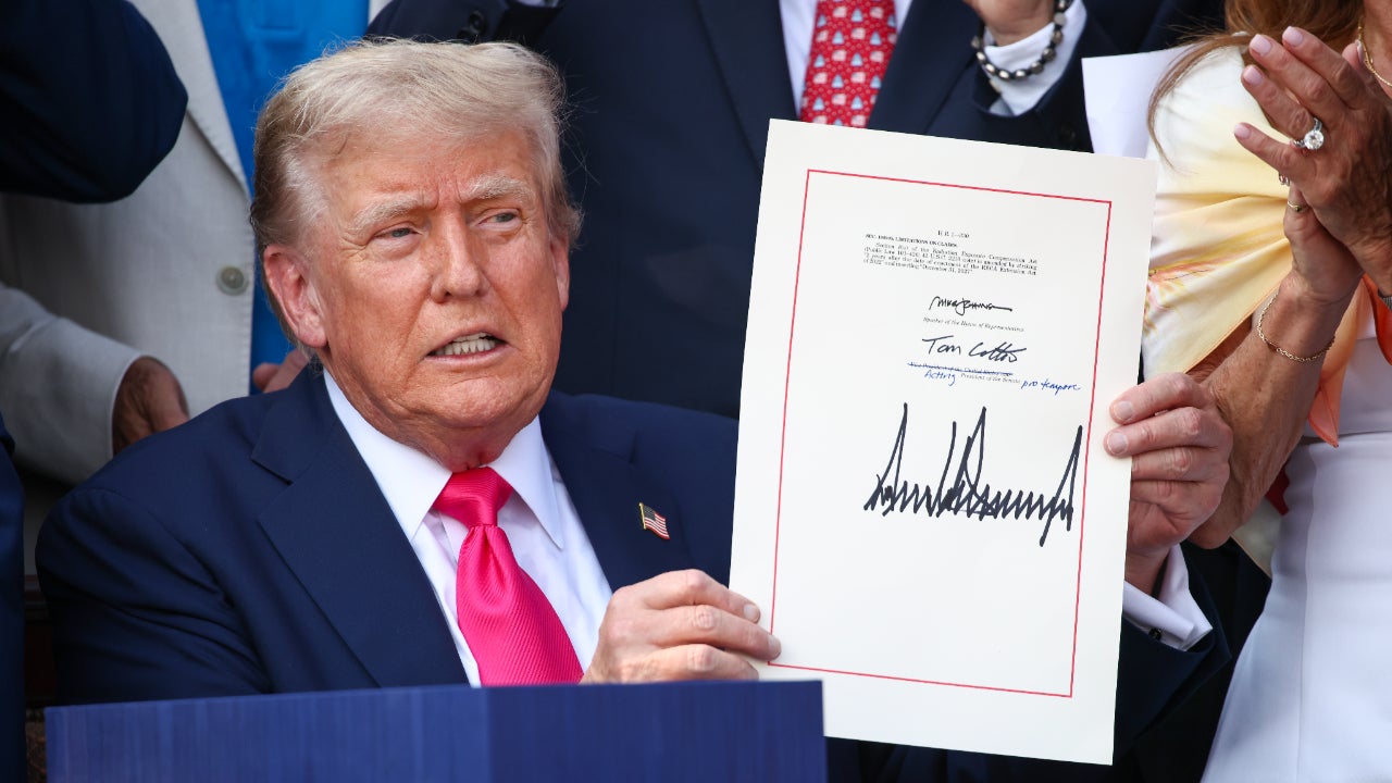 Donald Trump holds signed budget reconcilation bill