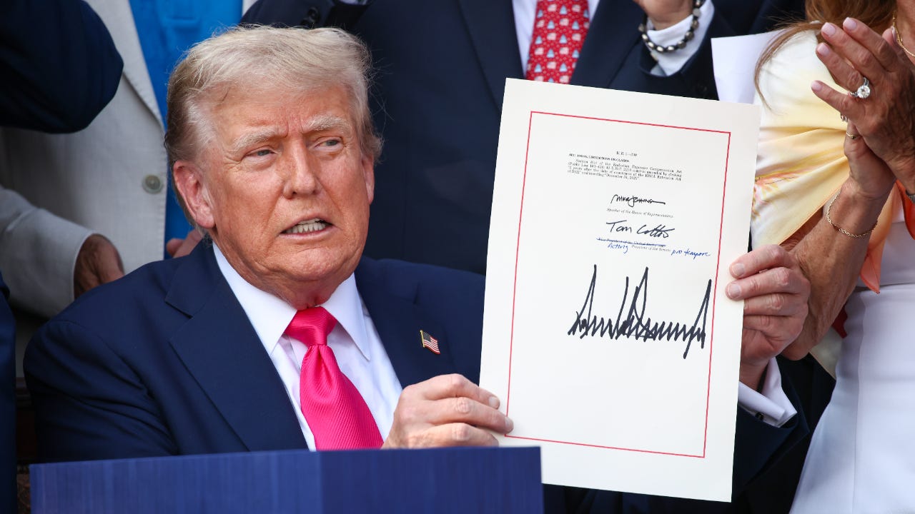Donald Trump holds signed budget reconcilation bill