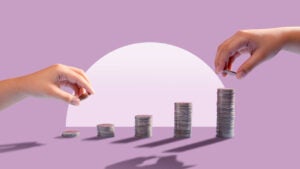 Two hands stacking coins as a visual representation of mutual funds.