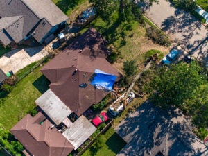 Aerial view of tree falling on house after storm in Houston