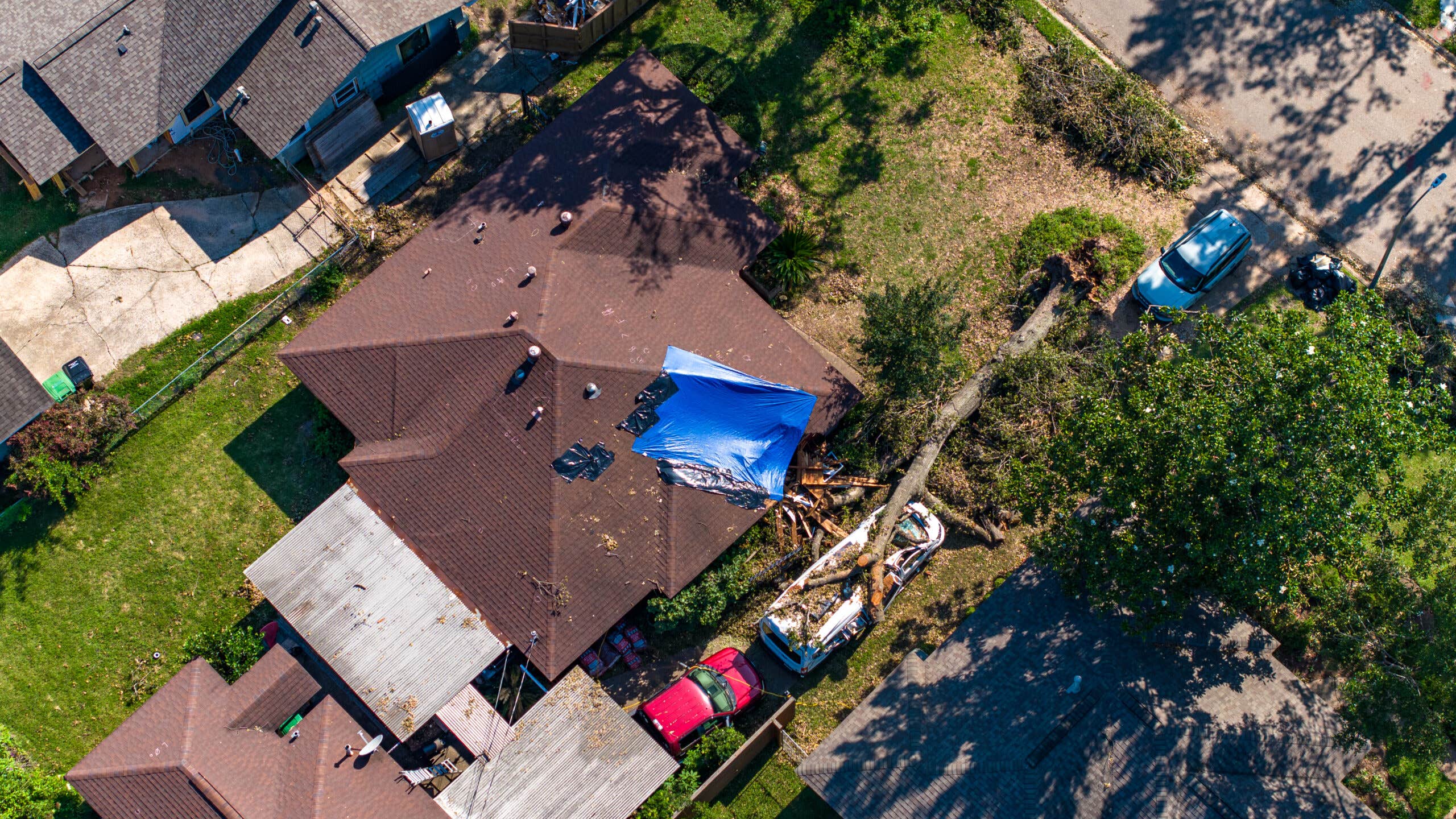 Aerial view of tree falling on house after storm in Houston