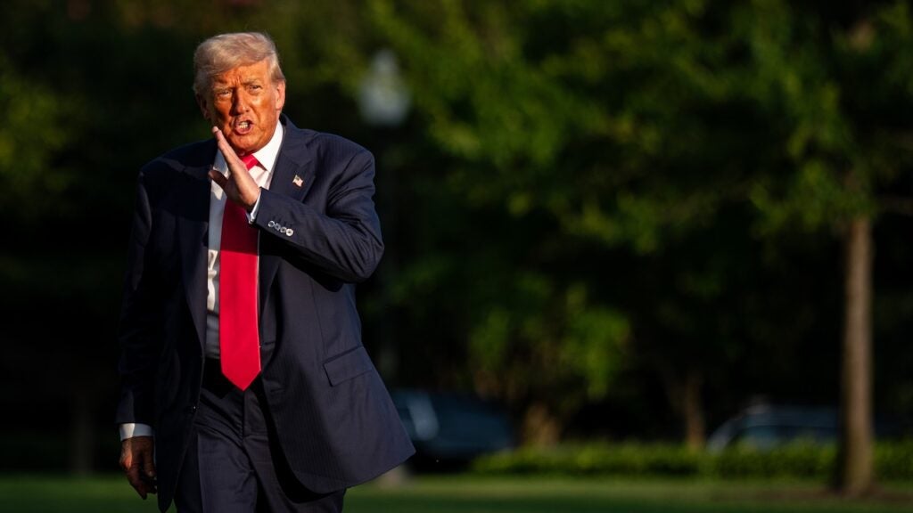 President Donald Trump walking on the White House Lawn