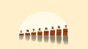 a stack of coins with letters on top of each one spelling out interest