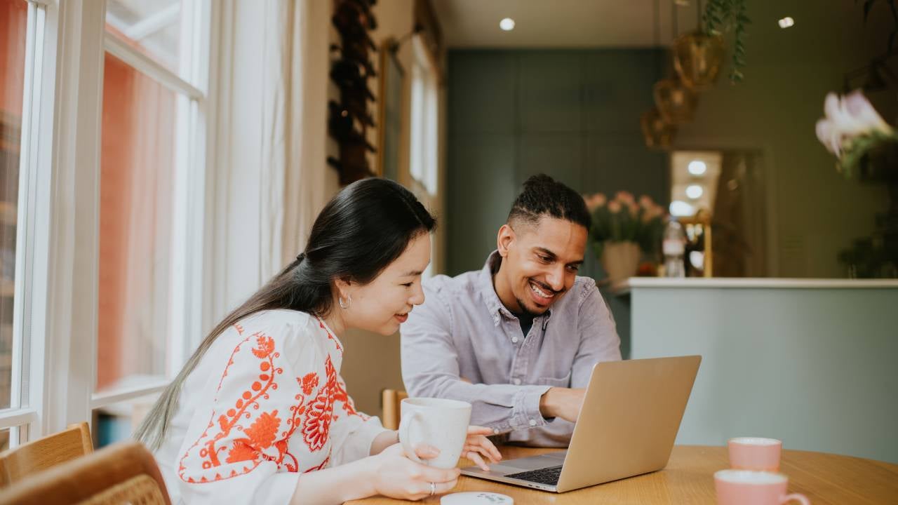 Couple looking at a laptop together.