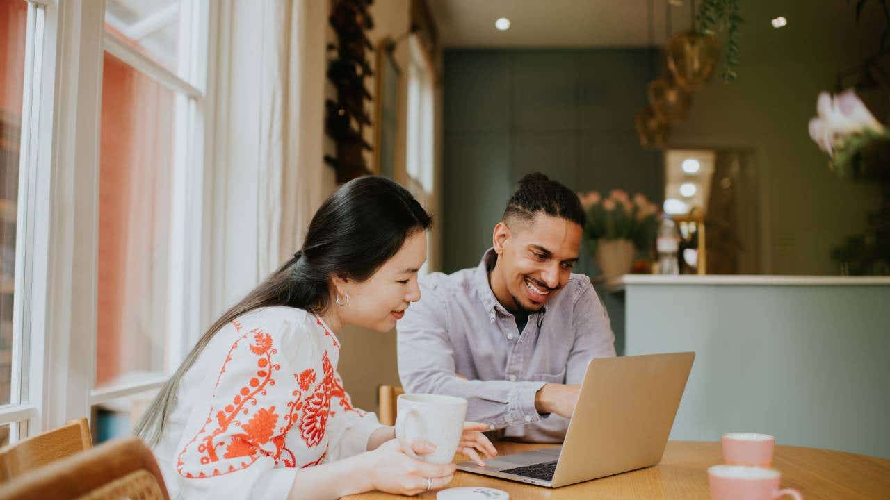 Couple looking at a laptop together.
