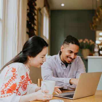Couple looking at a laptop together.