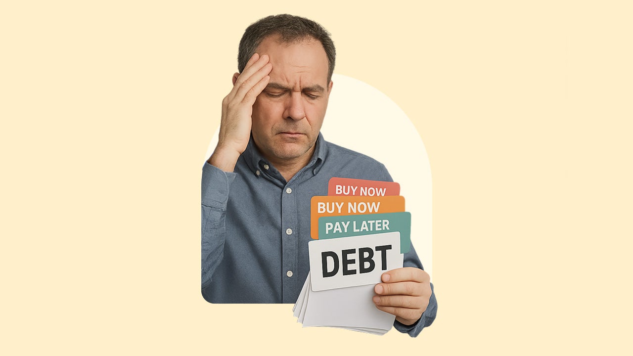 A man frowns, overwhelmed by debt.