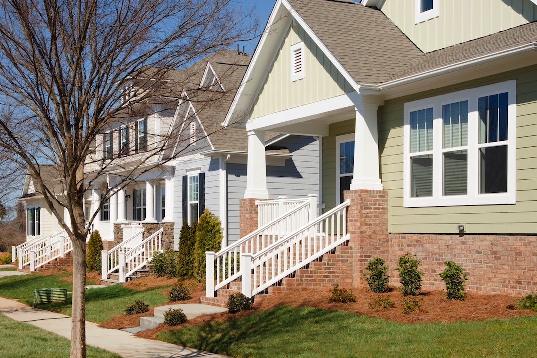 A row of an newly-constructed arts and crafts/bungalow-style homes.