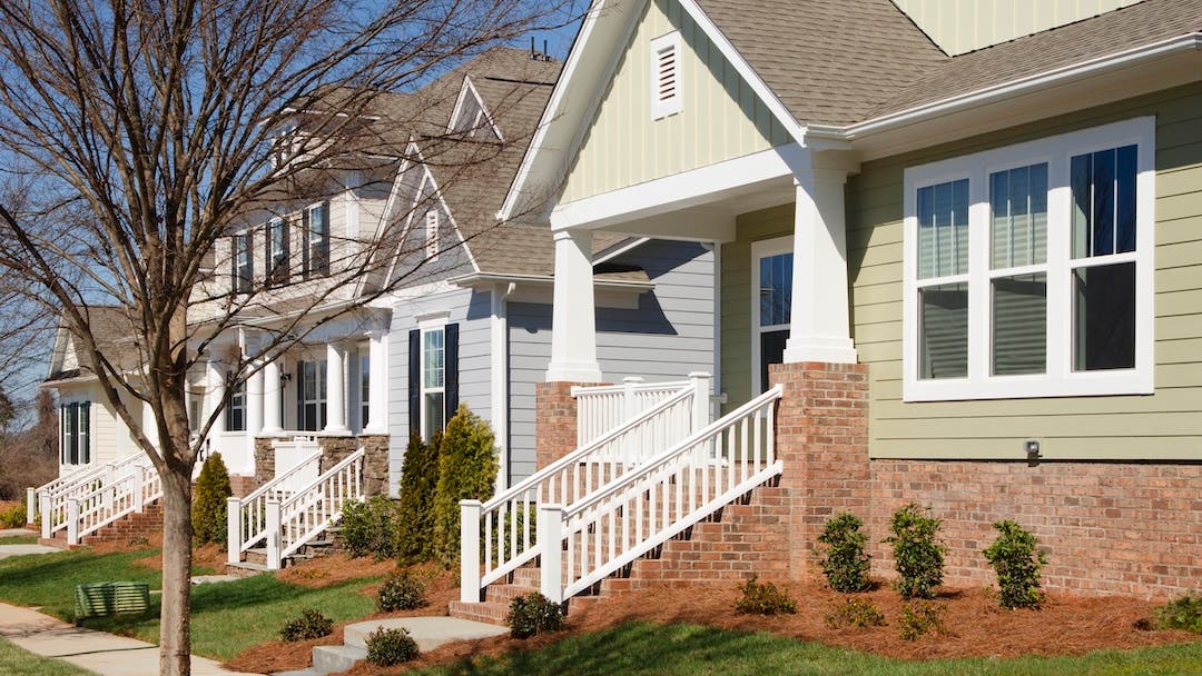 A row of an newly-constructed arts and crafts/bungalow-style homes.