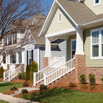 A row of an newly-constructed arts and crafts/bungalow-style homes.