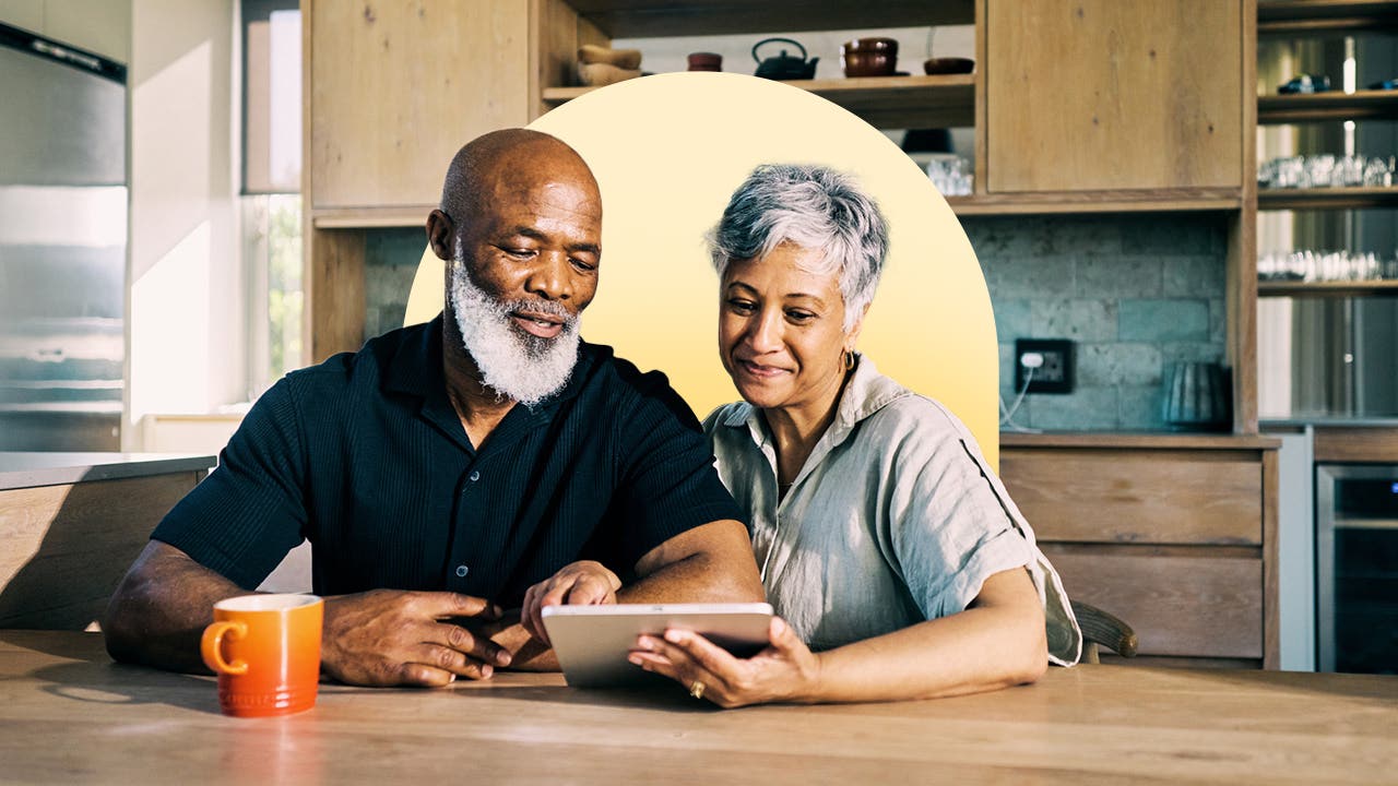 Couple looking at a tablet.